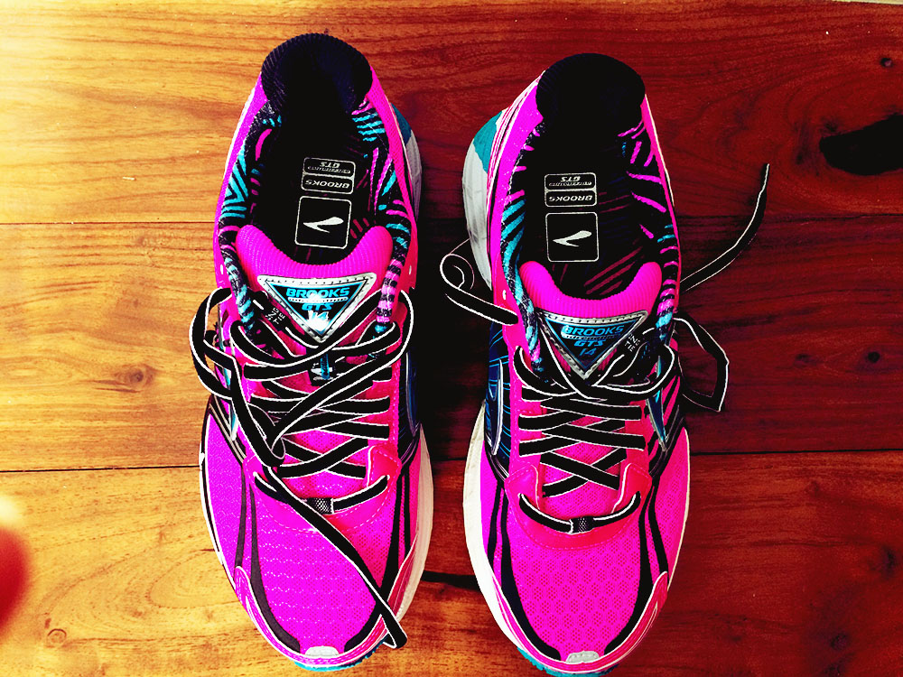 Hot pink Brooks running shoes.